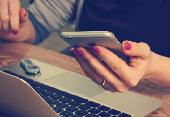 Person on phone with laptop