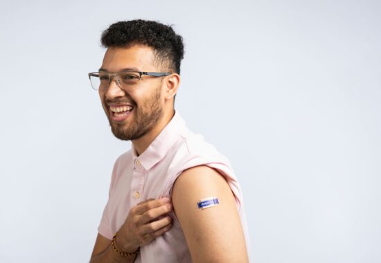 Man with plaster on after vaccine saying 'fight flu'
